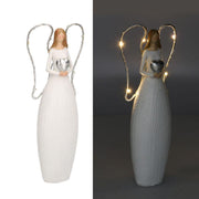 Ange en résine blanche avec led et coeur cm10x5h24